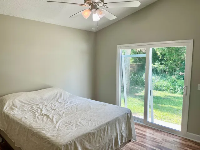 a bedroom with a bed and a large window