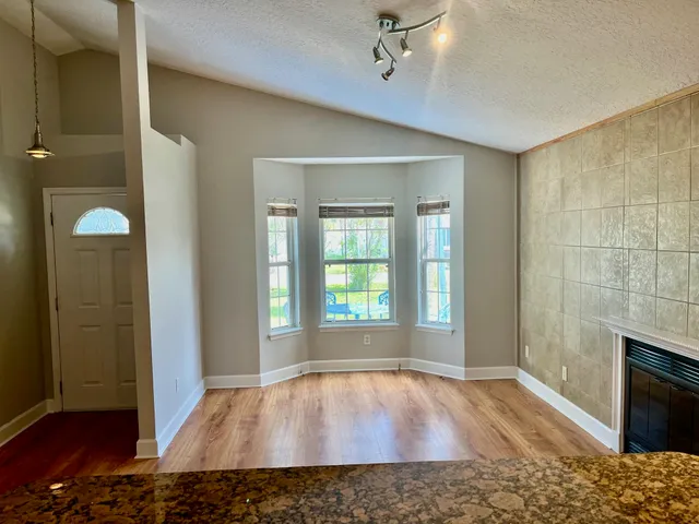 wooden floor in an empty room with a fireplace