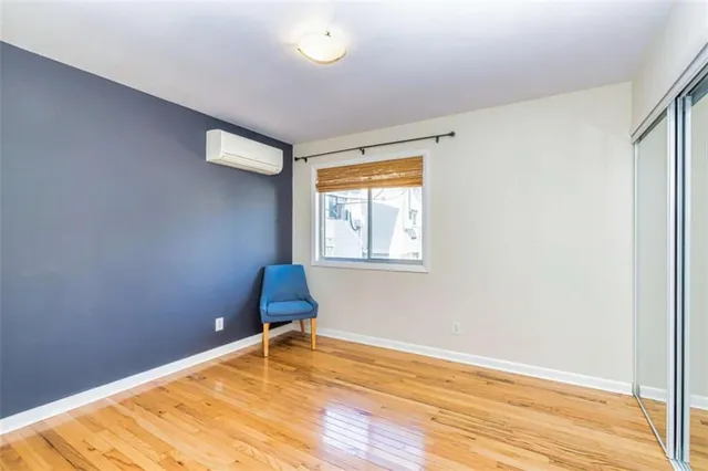 a room with a wooden floor and a window