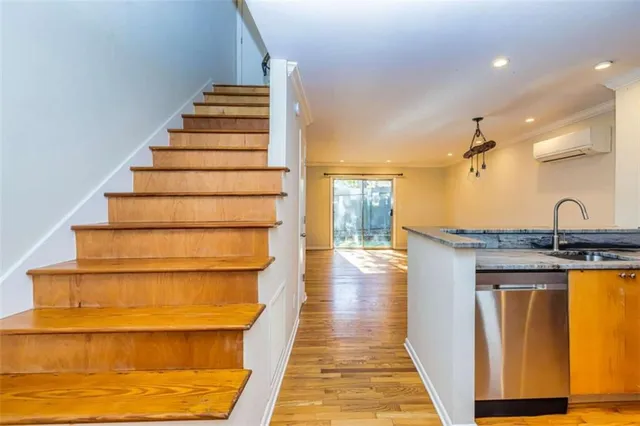 a view of entryway and hall with wooden floor