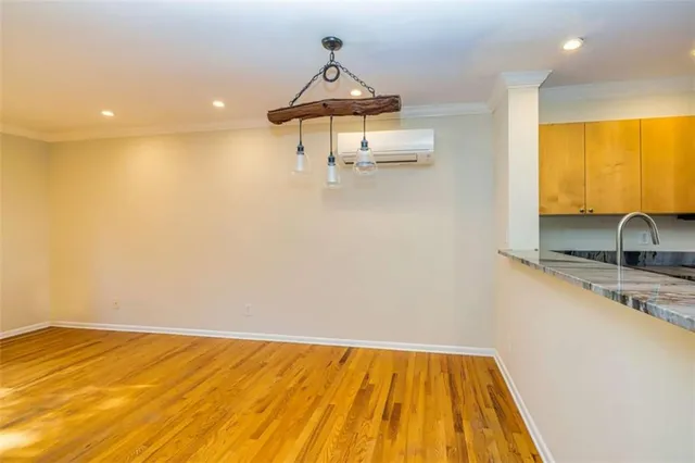 a view of storage and utility room with wooden floor