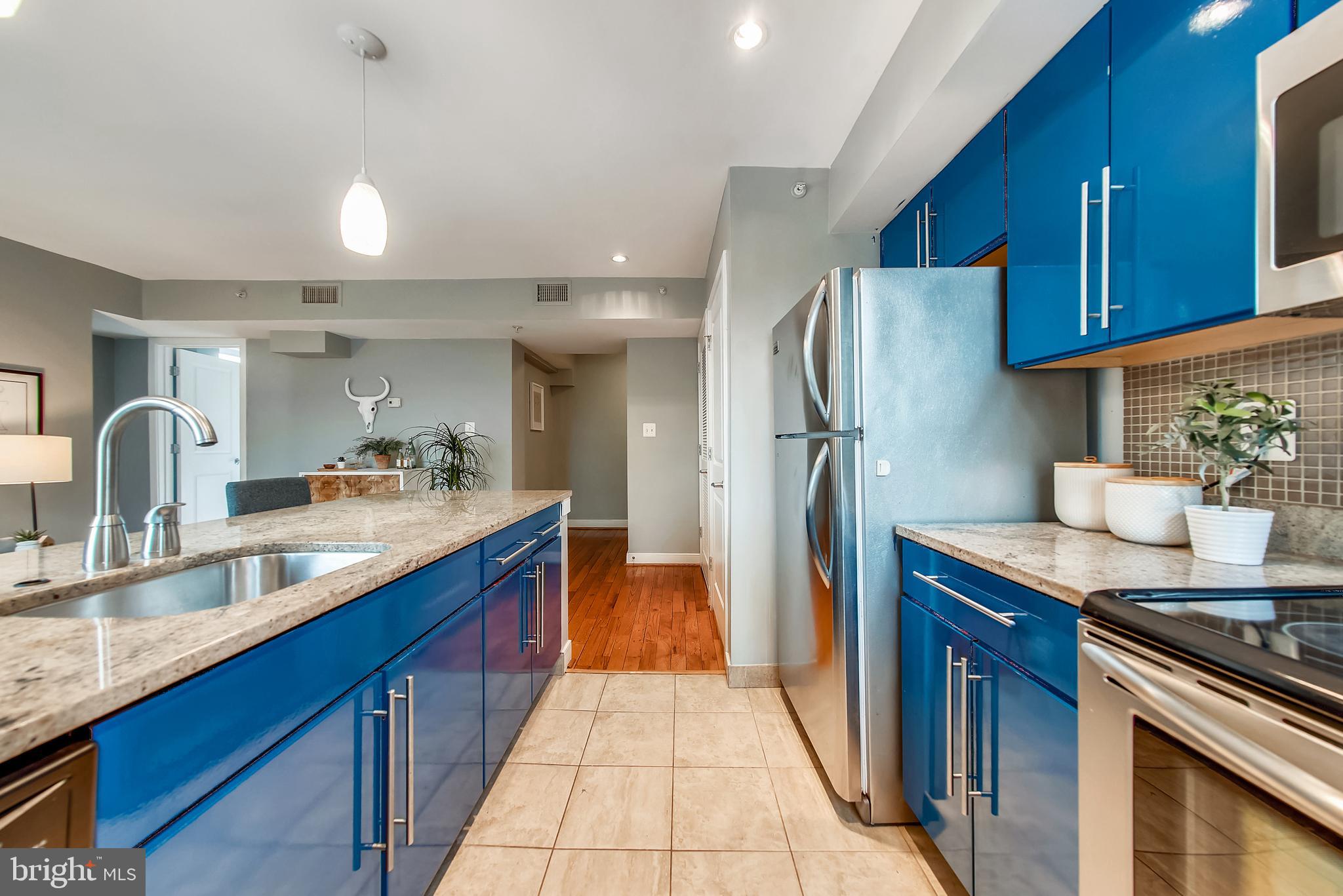 420 16th Street Southeast, Unit 306 Washington, DC 20003 - Photo 13 of 32 a kitchen with stainless steel appliances granite countertop a sink stove and refrigerator