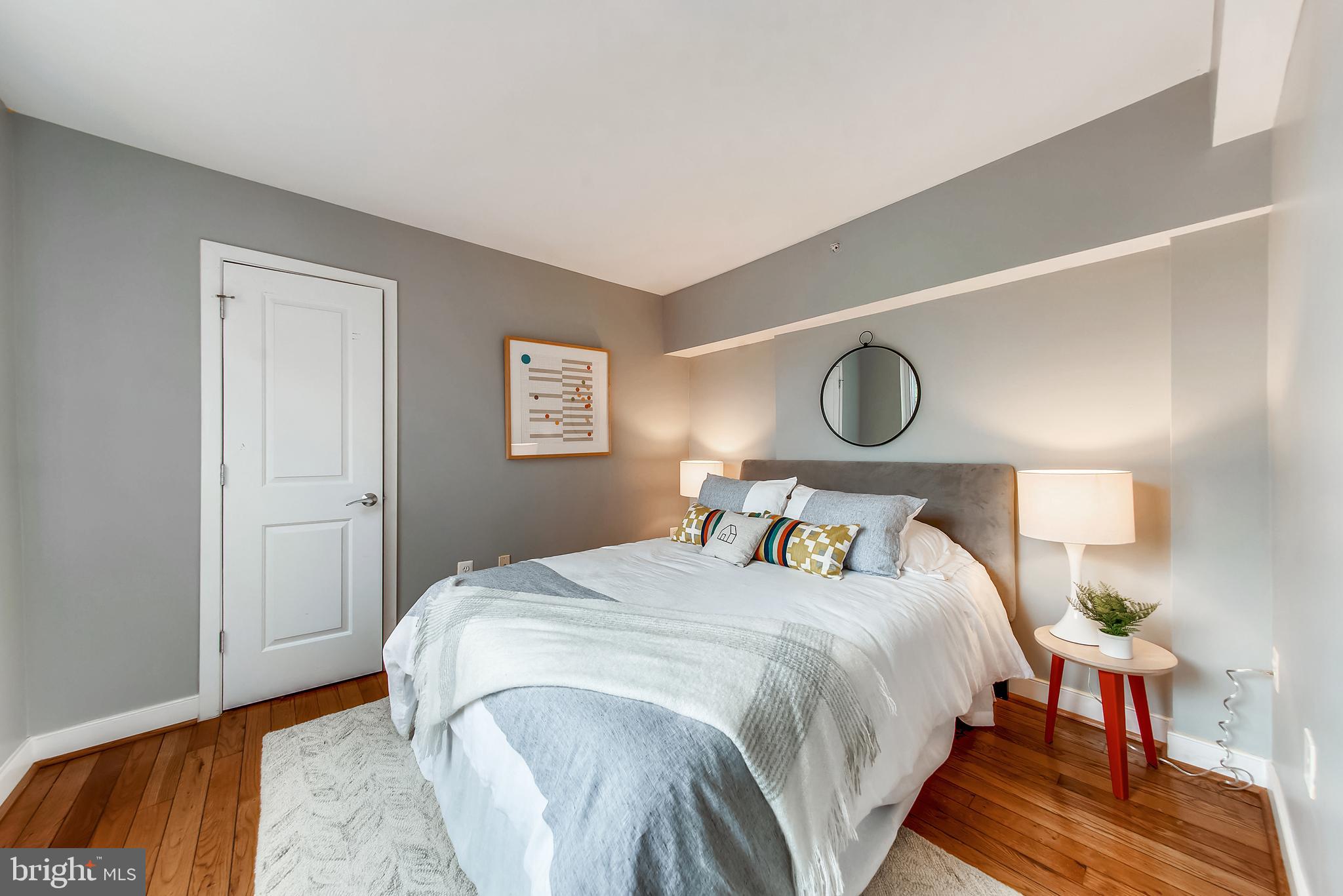 420 16th Street Southeast, Unit 306 Washington, DC 20003 - Photo 20 of 32 a bedroom with a bed and lamp