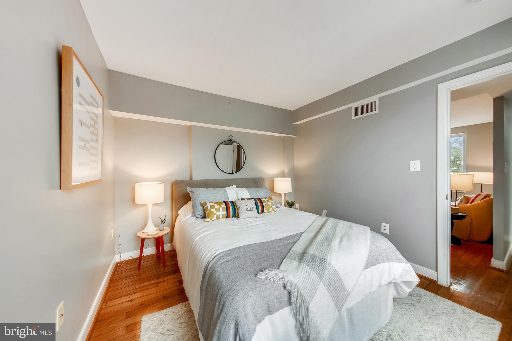 420 16th Street Southeast, Unit 306 Washington, DC 20003 - Photo 23 of 32 a bedroom with a bed and painting on the wall