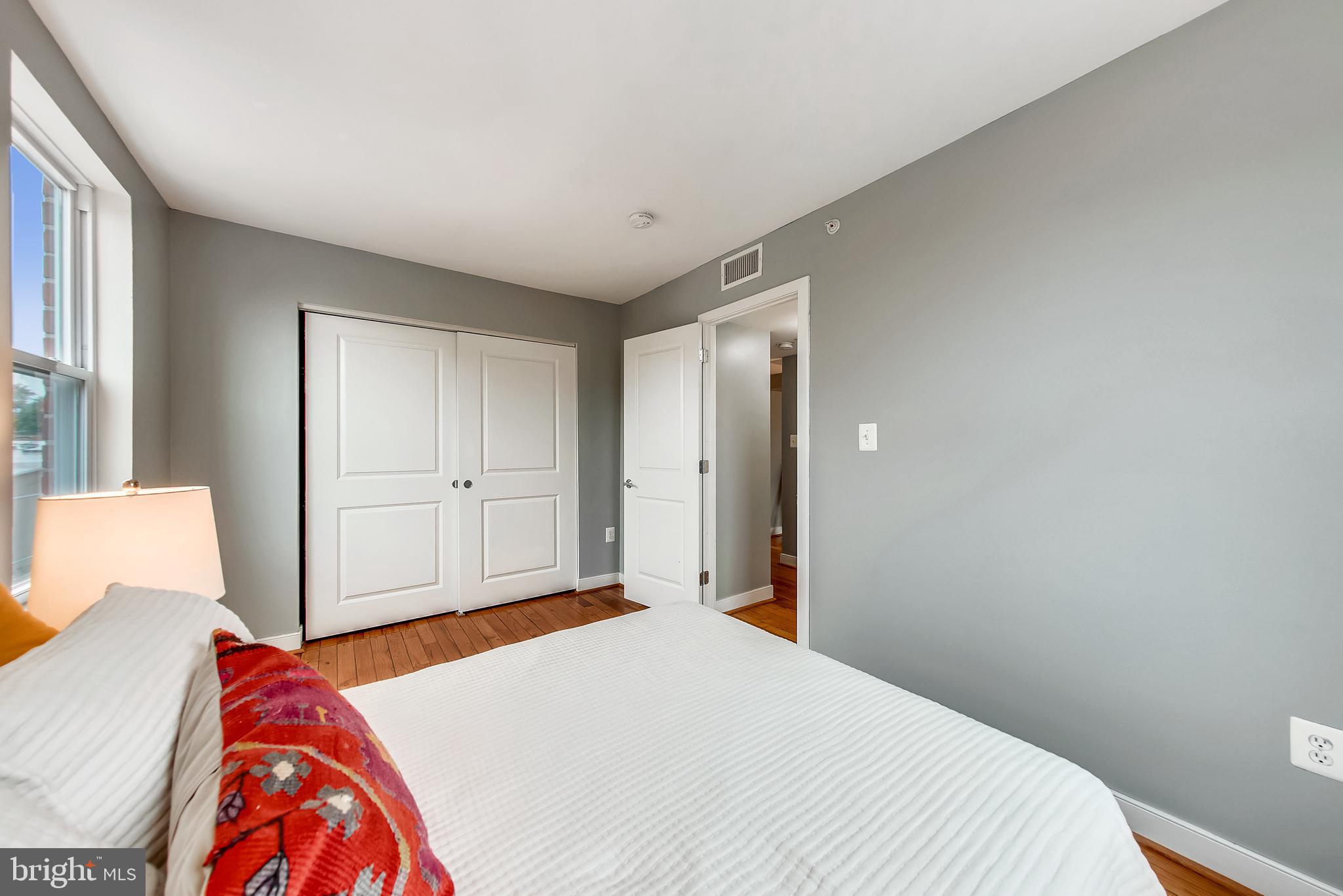 420 16th Street Southeast, Unit 306 Washington, DC 20003 - Photo 26 of 32 a bedroom with a bed and a painting on the wall