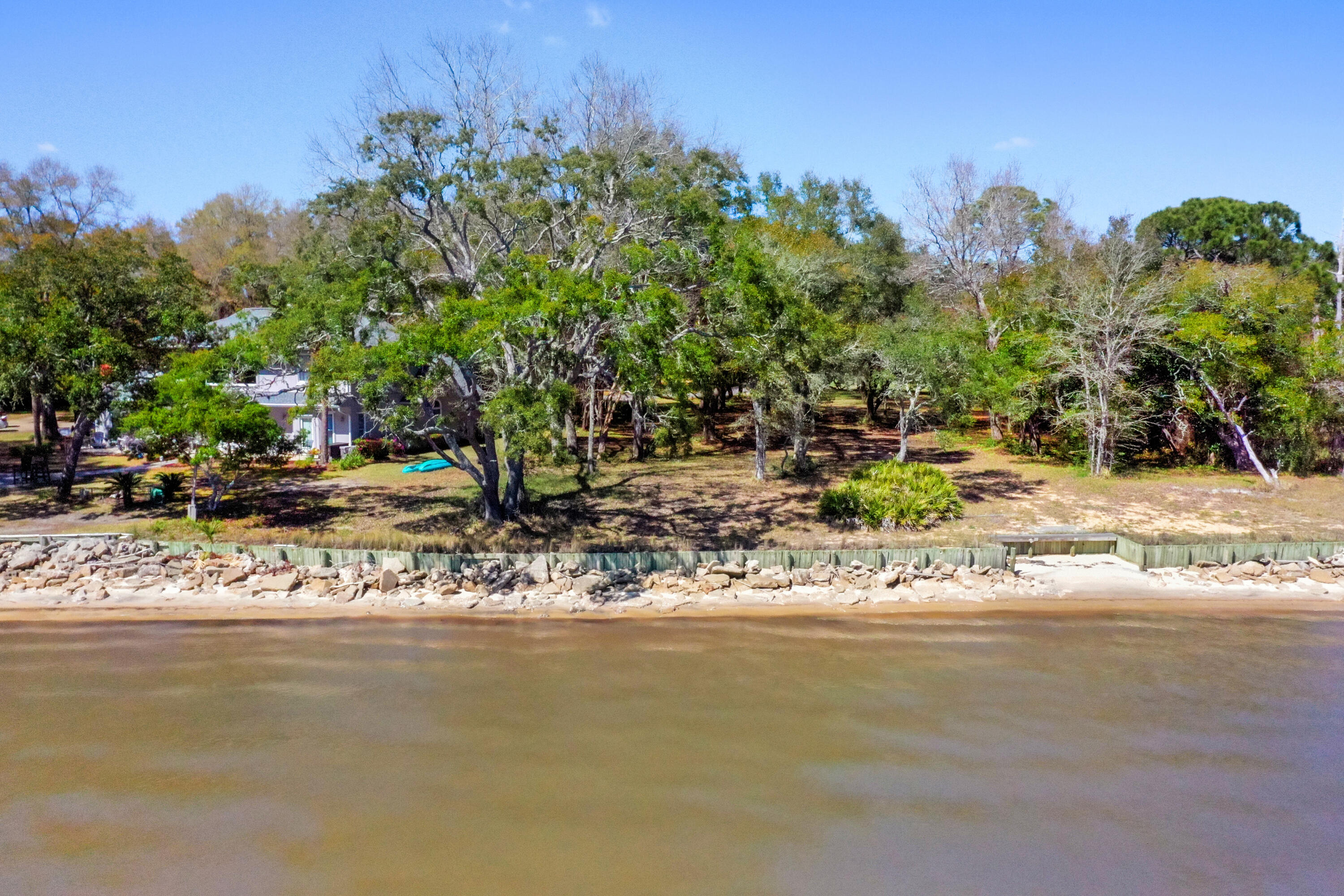 Lot 9 Cedar Beach Cove Freeport, FL 32439 - Photo 19 of 41 a view of a tree next to a lake with a large tree
