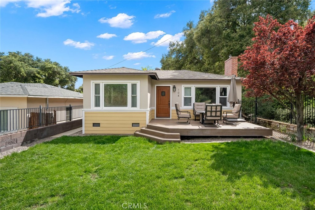a view of a house with a backyard and a patio