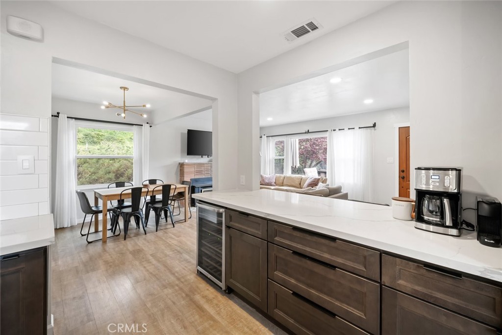104 16th Street Paso Robles, CA 93446 - Photo 12 of 40 a open kitchen with stainless steel appliances granite countertop a stove a sink a dining table and chairs with wooden floor