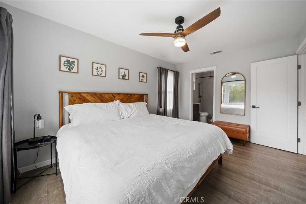 104 16th Street Paso Robles, CA 93446 - Photo 16 of 40 a bedroom with a large bed and a chandelier