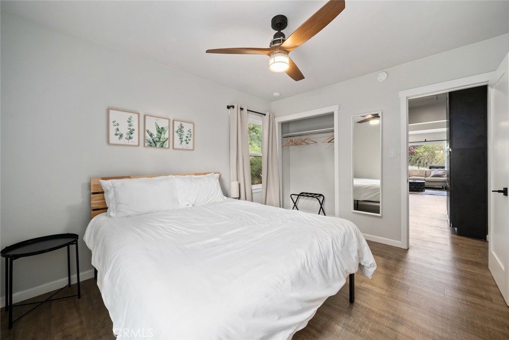 104 16th Street Paso Robles, CA 93446 - Photo 22 of 40 a bedroom with a large bed and a chandelier