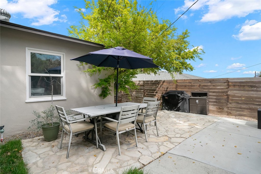 104 16th Street Paso Robles, CA 93446 - Photo 35 of 40 a view of a patio with table and chairs under an umbrella