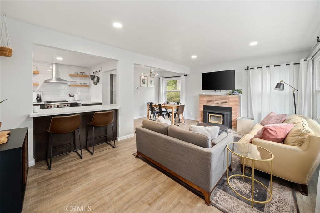 104 16th Street Paso Robles, CA 93446 - Photo 4 of 40 a living room with furniture a fireplace and a flat screen tv