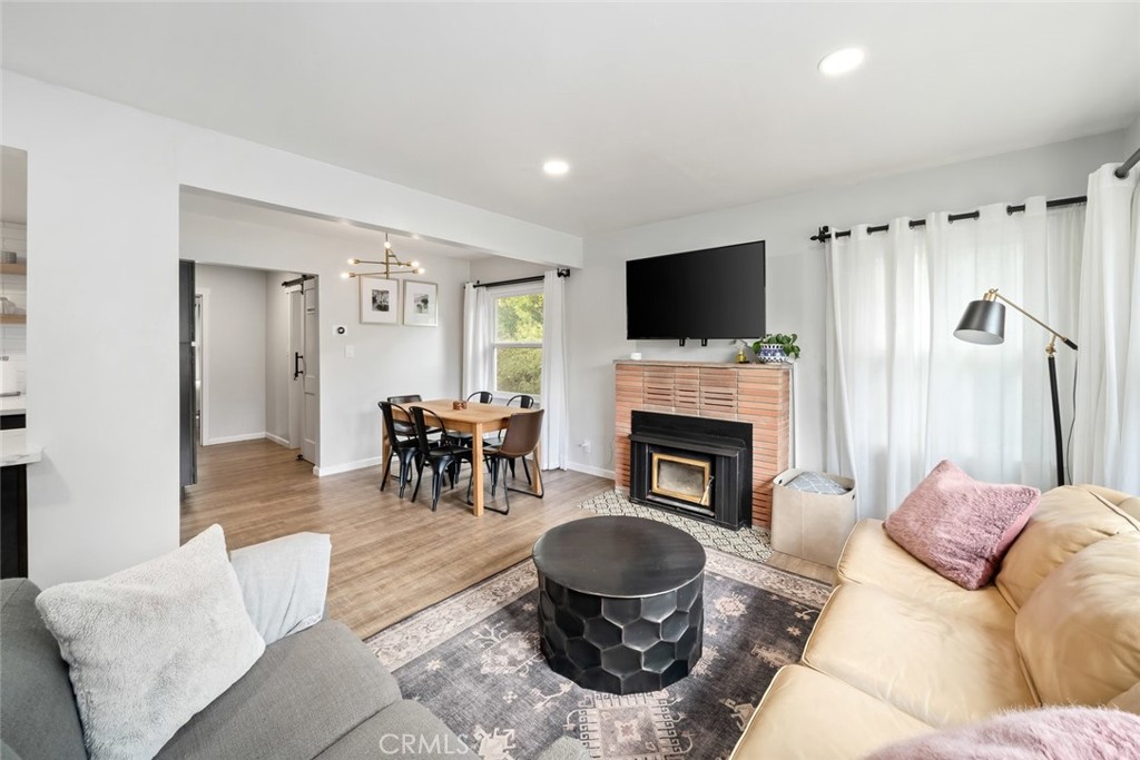104 16th Street Paso Robles, CA 93446 - Photo 5 of 40 a living room with furniture a flat screen tv and a fireplace