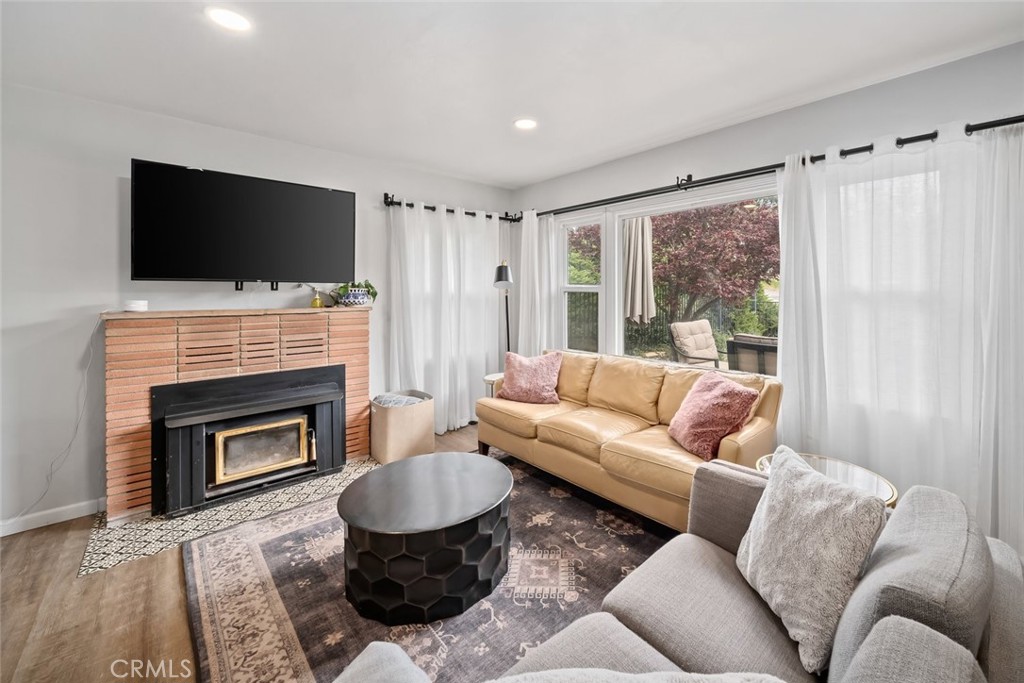 104 16th Street Paso Robles, CA 93446 - Photo 6 of 40 a living room with furniture a flat screen tv and a fireplace