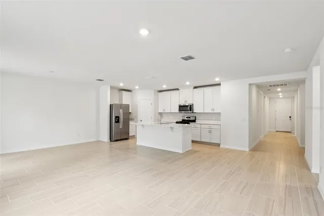 a view of a kitchen with refrigerator sink and stove