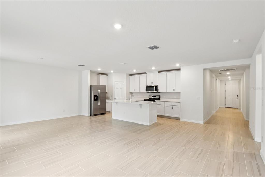 28009 Poppy Court Leesburg, FL 34748 - Photo 14 of 35 a view of a kitchen with refrigerator sink and stove