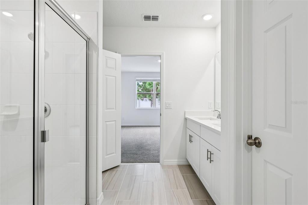 28009 Poppy Court Leesburg, FL 34748 - Photo 22 of 35 a bathroom with a bathtub and a shower