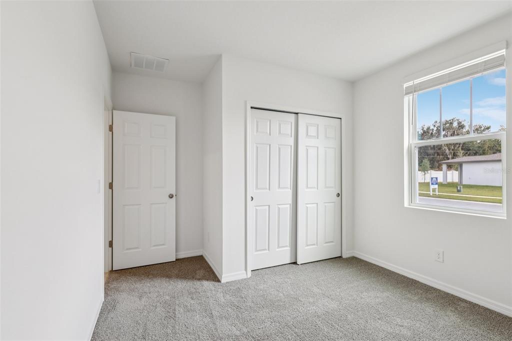 28009 Poppy Court Leesburg, FL 34748 - Photo 24 of 35 a view of an empty room with window and kitchen view