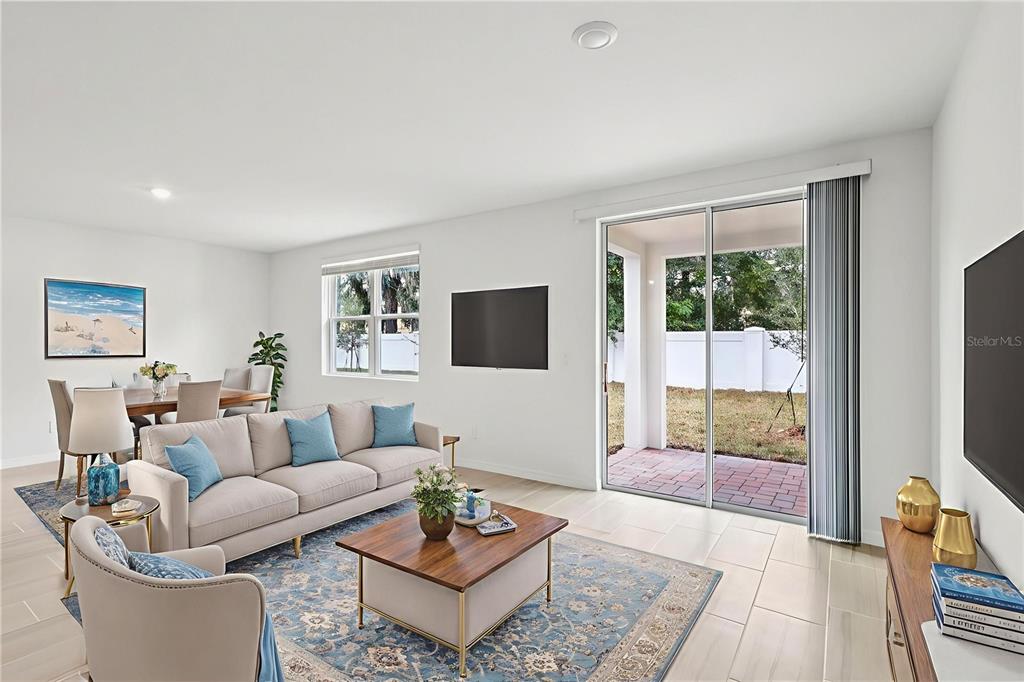 28009 Poppy Court Leesburg, FL 34748 - Photo 3 of 35 a living room with furniture and a flat screen tv