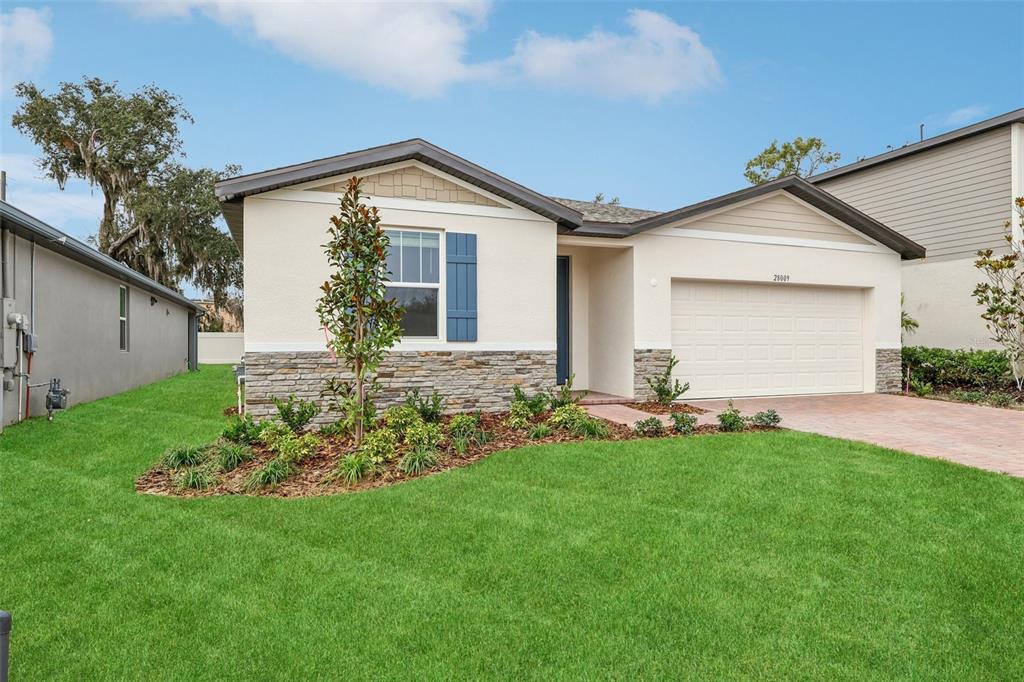 28009 Poppy Court Leesburg, FL 34748 - Photo 34 of 35 a front view of house with a garden