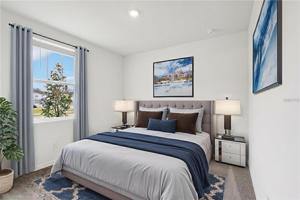 28009 Poppy Court Leesburg, FL 34748 - Photo 5 of 35 a bedroom with a bed and a painting on the wall