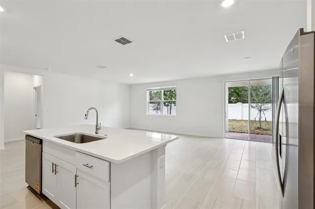 a kitchen with a sink and large window