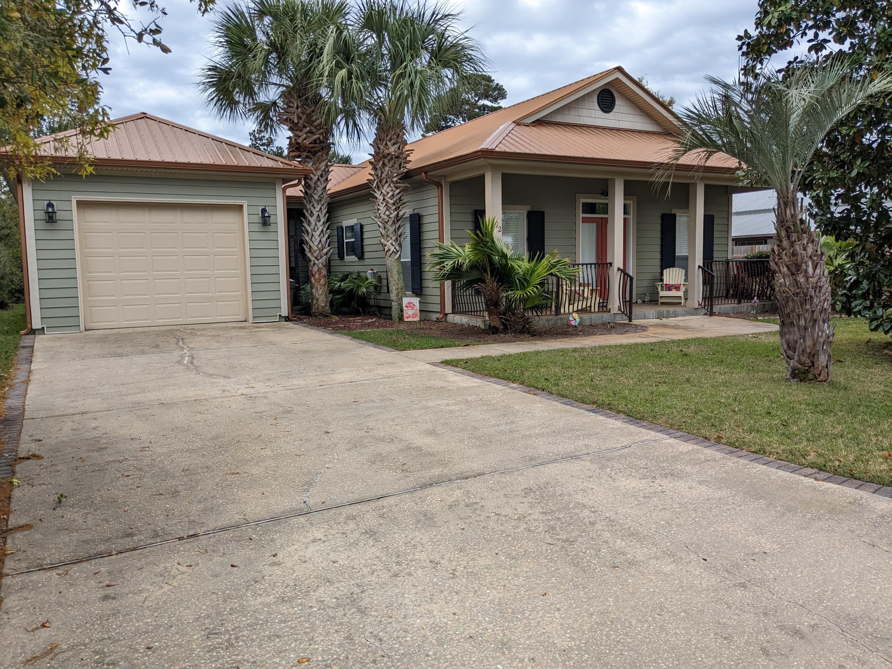 192 Birch Street Santa Rosa Beach, FL 32459 - Photo 1 of 51 a front view of a house with plants and garden