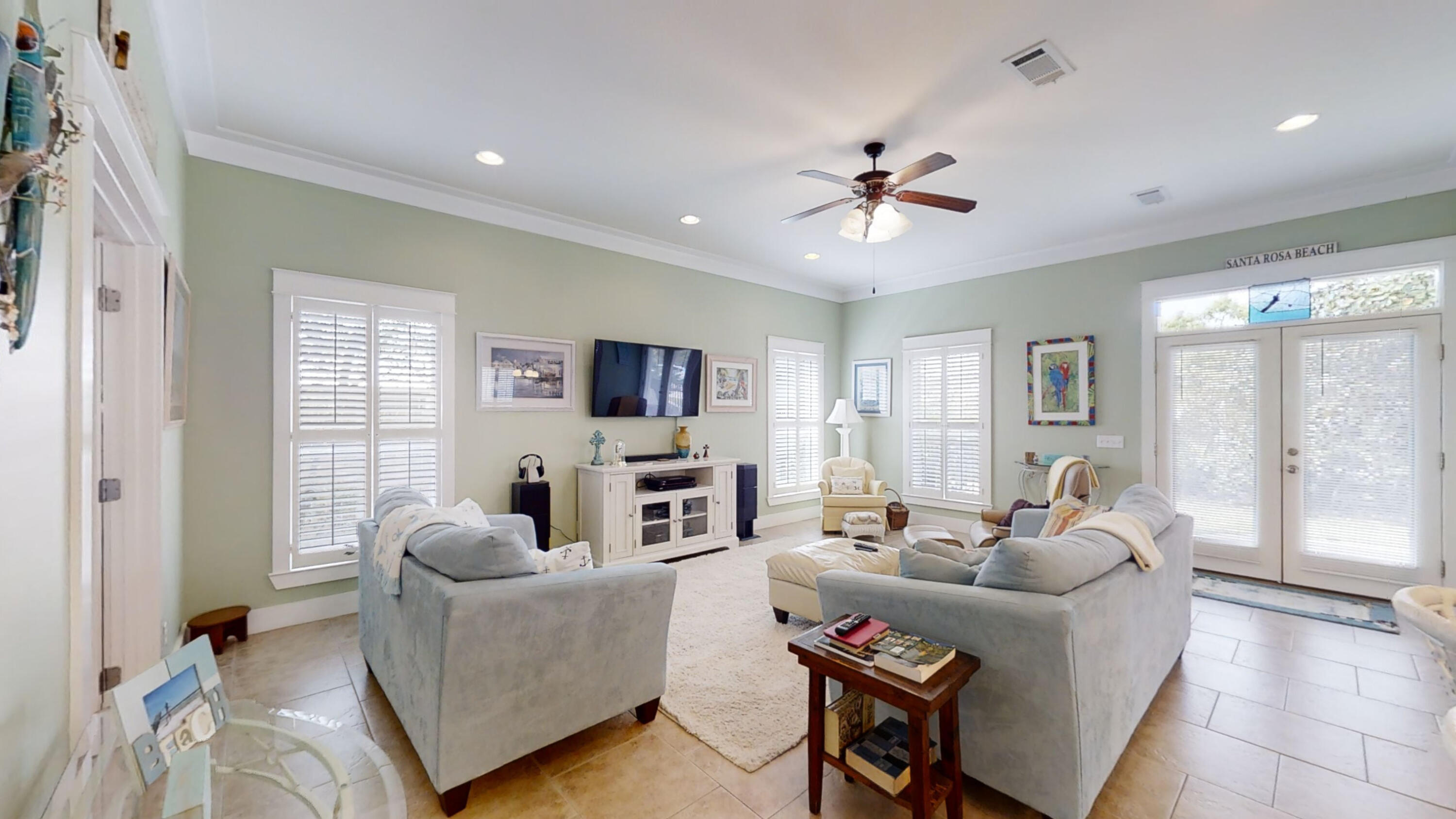 192 Birch Street Santa Rosa Beach, FL 32459 - Photo 16 of 51 a living room with furniture a ceiling fan and a flat screen tv