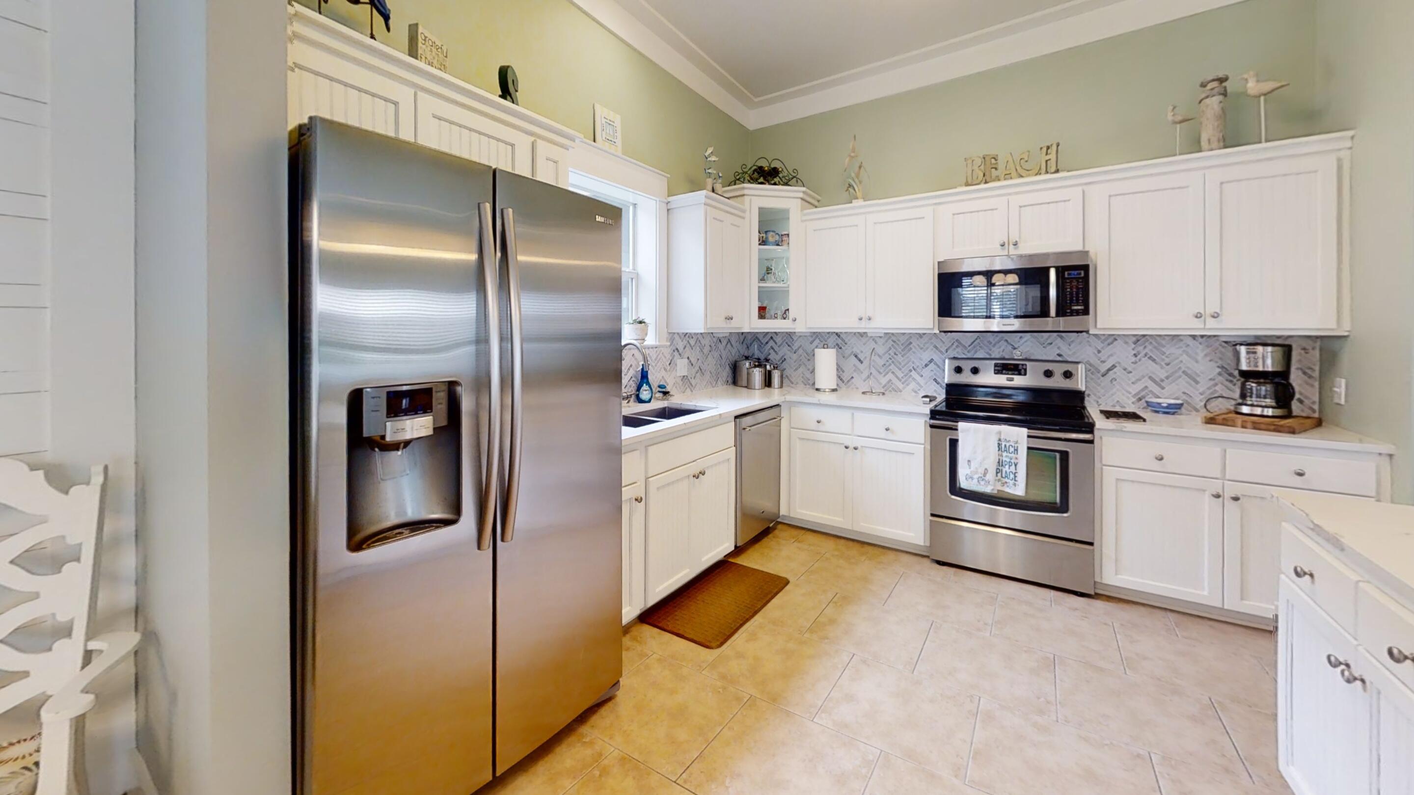 192 Birch Street Santa Rosa Beach, FL 32459 - Photo 21 of 51 a white kitchen with stainless steel appliances