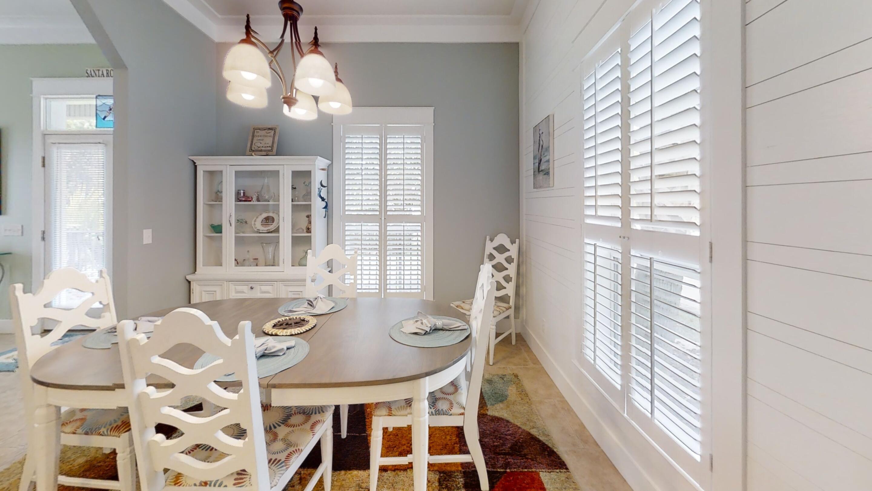 192 Birch Street Santa Rosa Beach, FL 32459 - Photo 23 of 51 a view of a dining room with furniture and chandelier