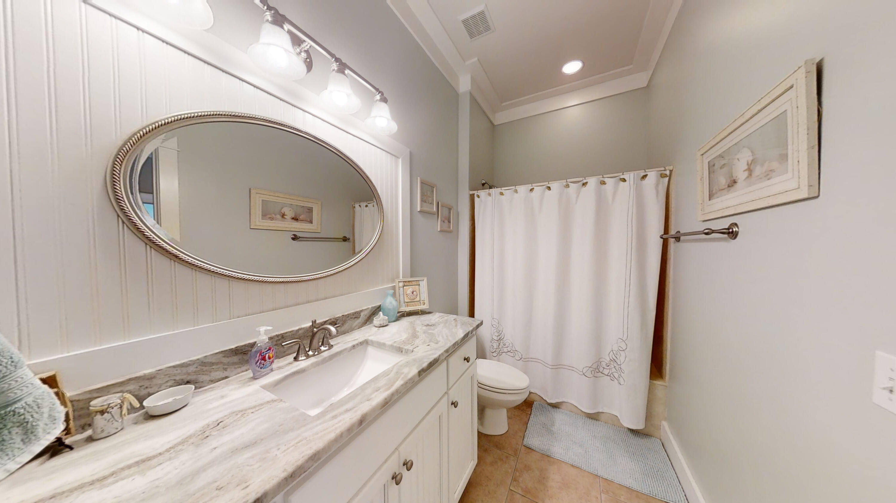 192 Birch Street Santa Rosa Beach, FL 32459 - Photo 28 of 51 a bathroom with a granite countertop double vanity sink a mirror and a toilet