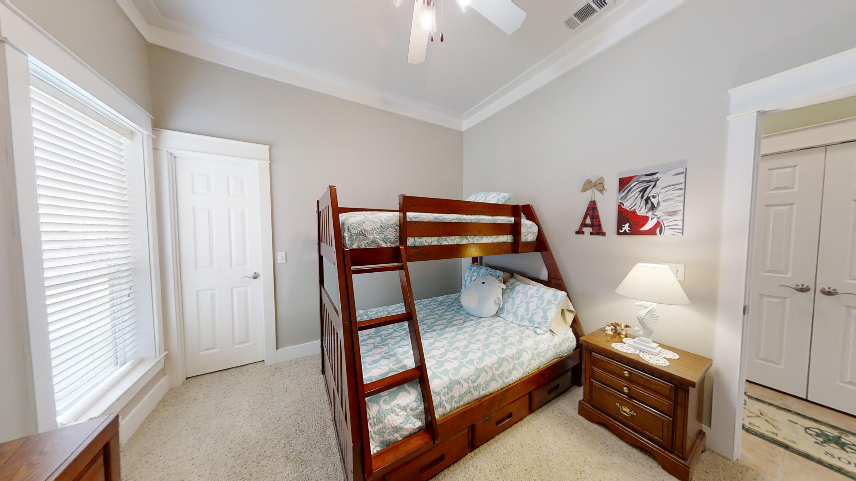 192 Birch Street Santa Rosa Beach, FL 32459 - Photo 32 of 51 a bedroom with a bed and a chandelier
