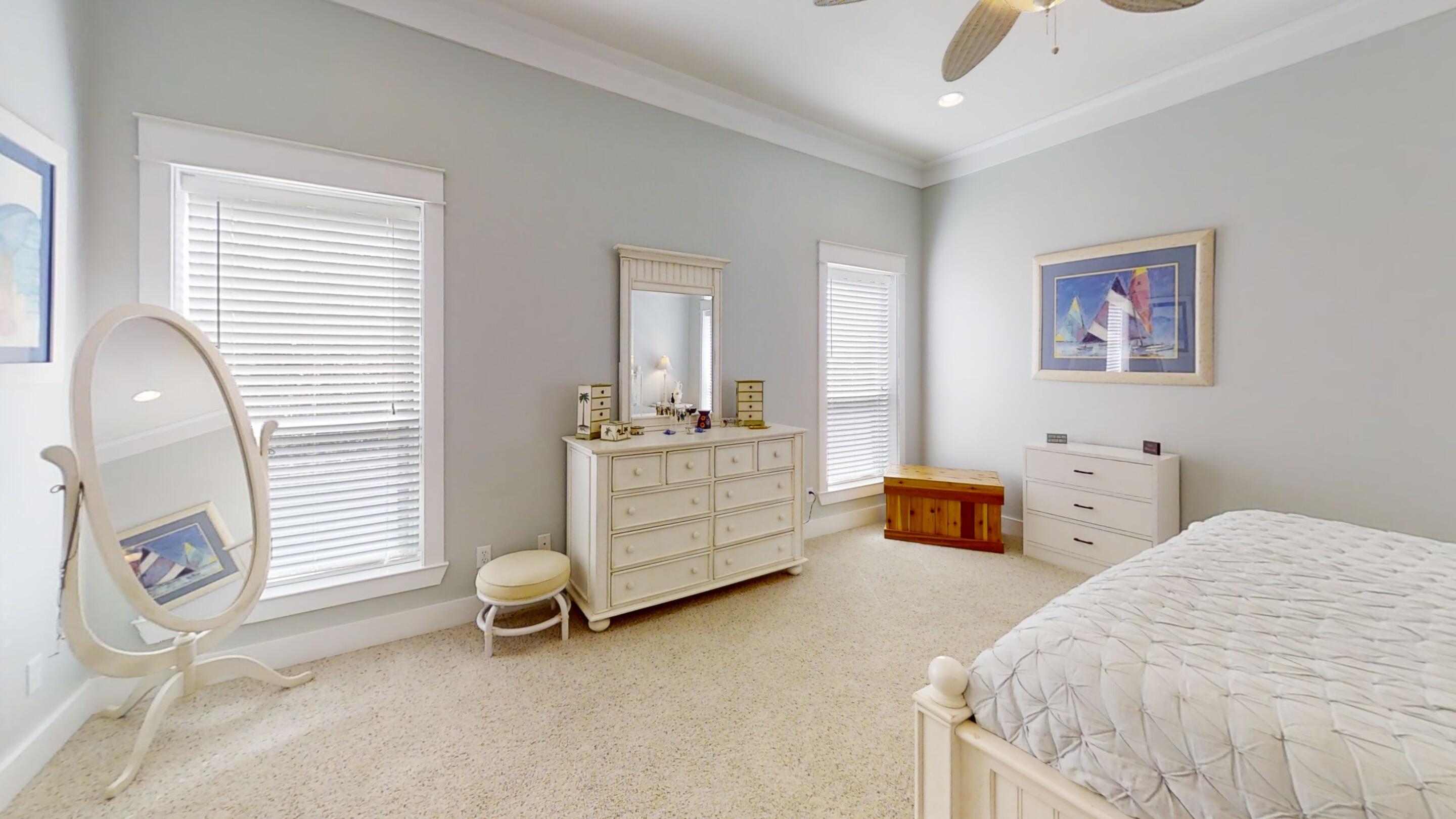 192 Birch Street Santa Rosa Beach, FL 32459 - Photo 33 of 51 a bedroom with bed and a chandelier