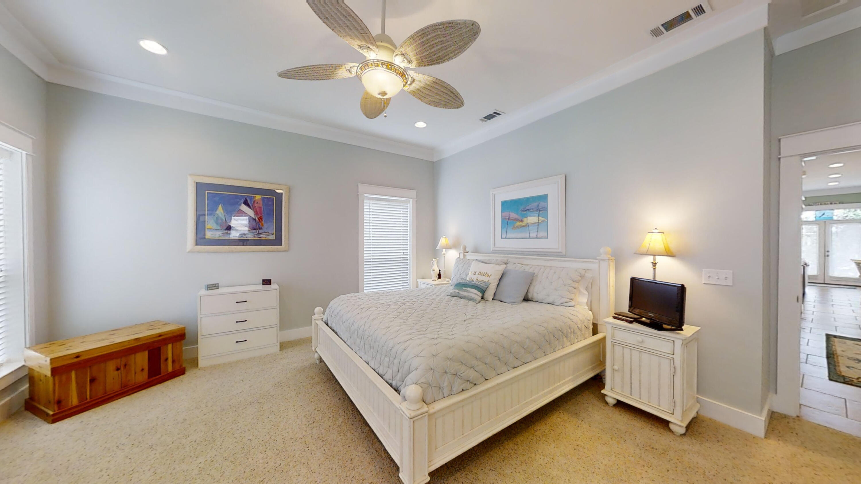 192 Birch Street Santa Rosa Beach, FL 32459 - Photo 34 of 51 a bedroom with a bed and a chandelier