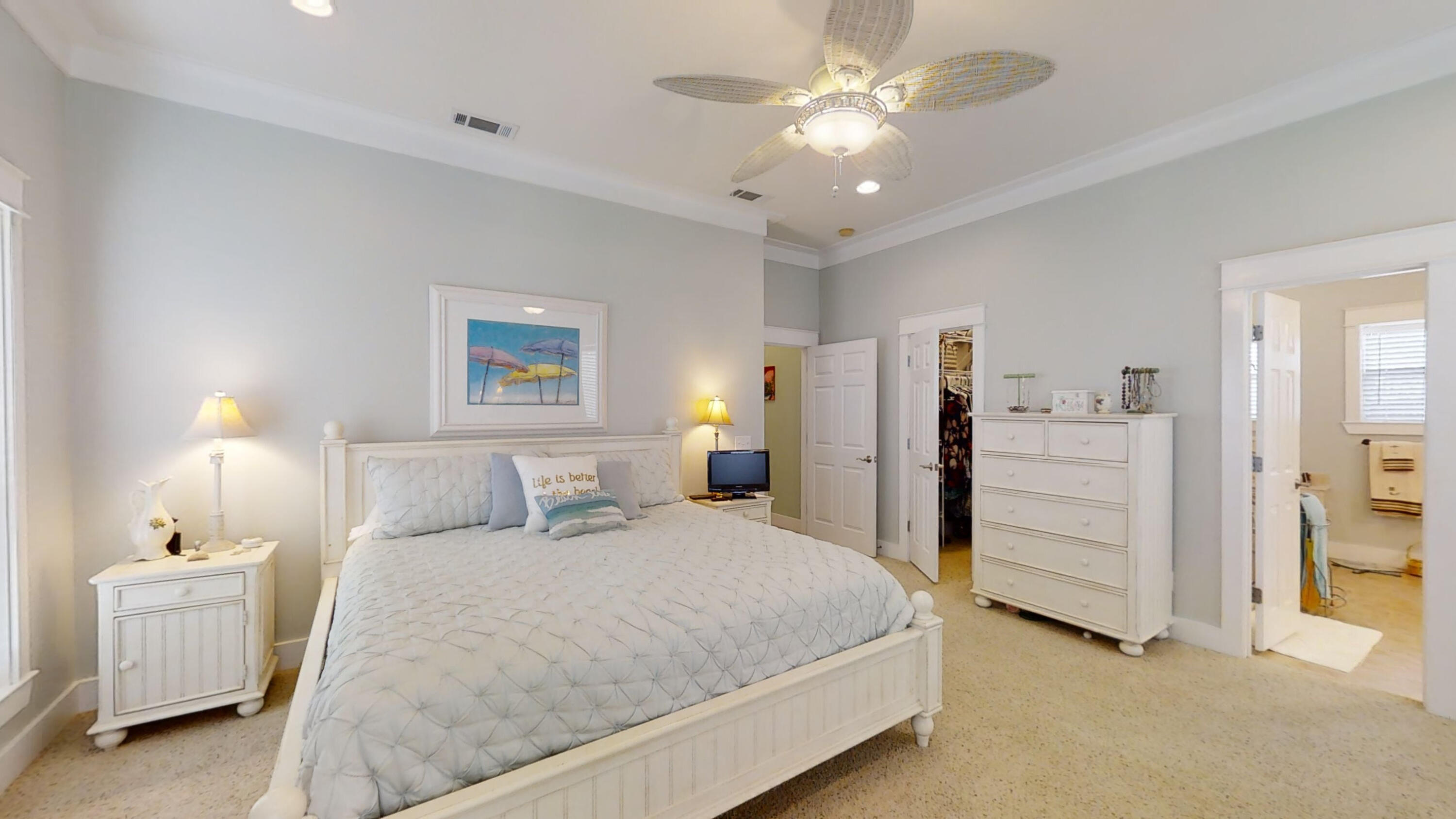192 Birch Street Santa Rosa Beach, FL 32459 - Photo 36 of 51 a bedroom with a bed and a chandelier