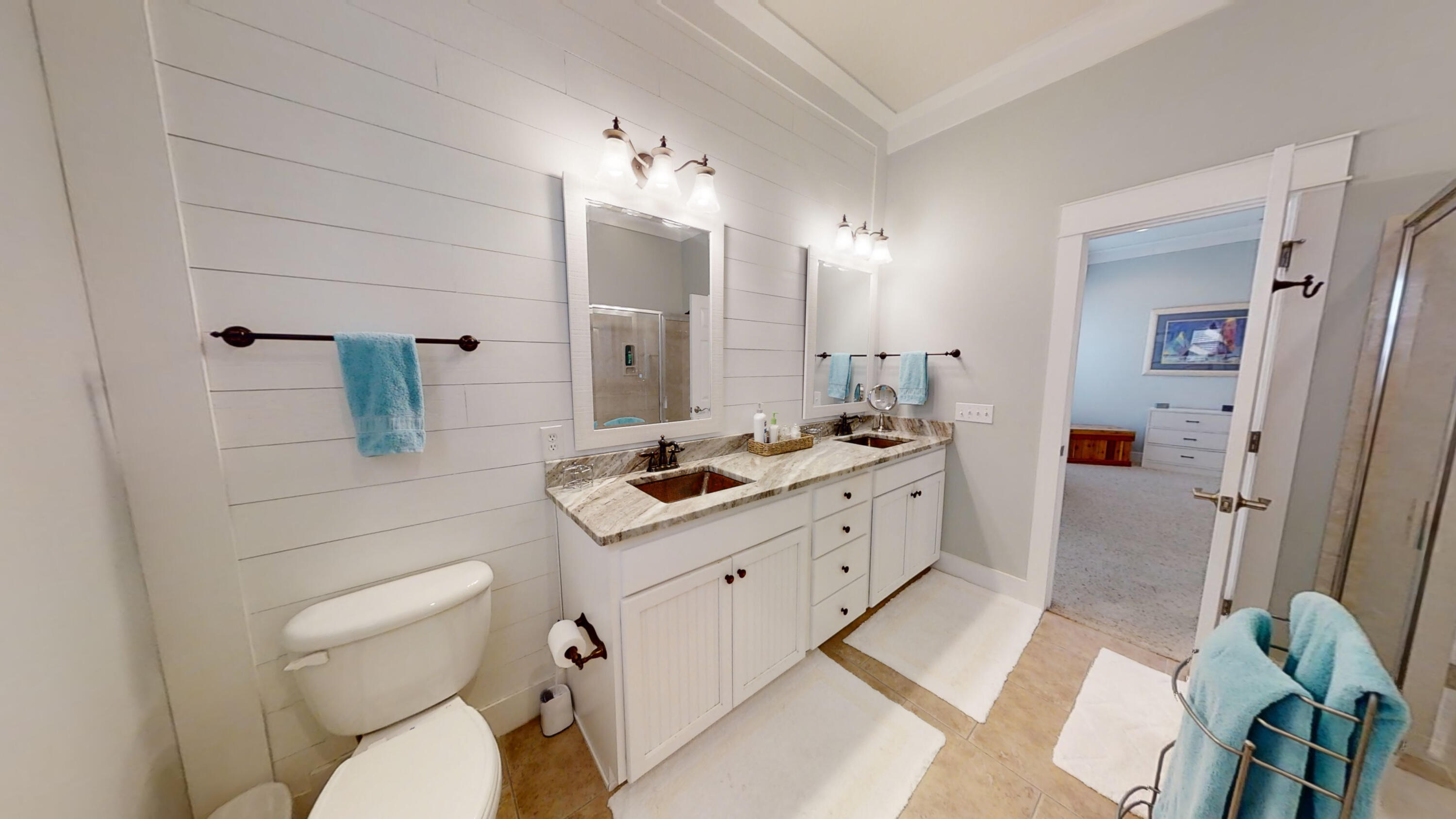 192 Birch Street Santa Rosa Beach, FL 32459 - Photo 38 of 51 a spacious bathroom with a double vanity sink a mirror and a toilet