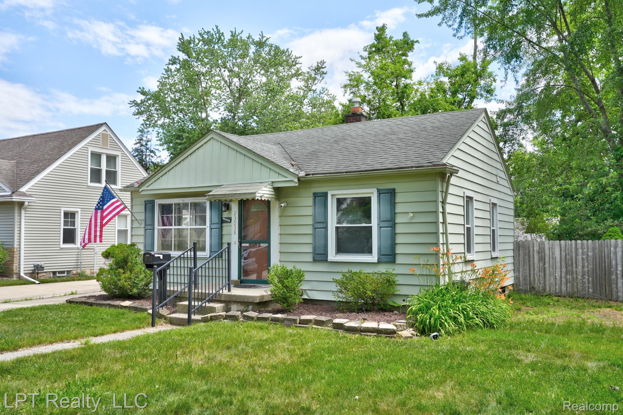 23038 Violet Street Farmington, MI 48336 - Photo 2 of 29 Mint green siding exterior featuring a covered entry