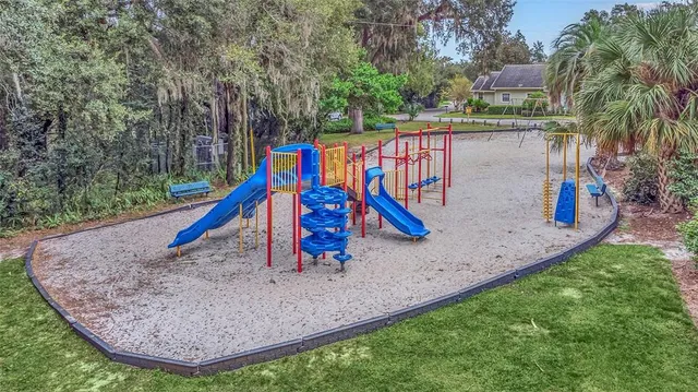 a view of a house with pool and sitting area