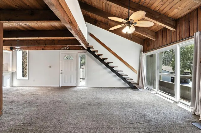 a view of a room with white walls and stairs