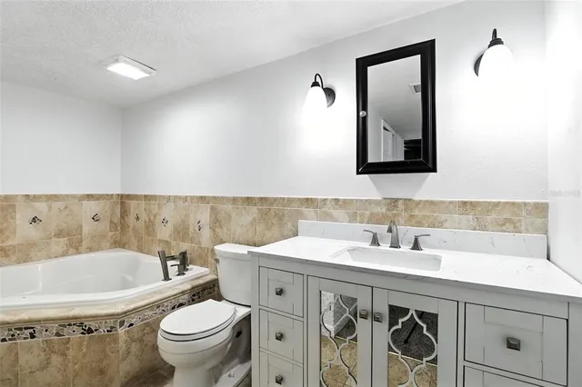 a bathroom with a bathtub and a toilet
