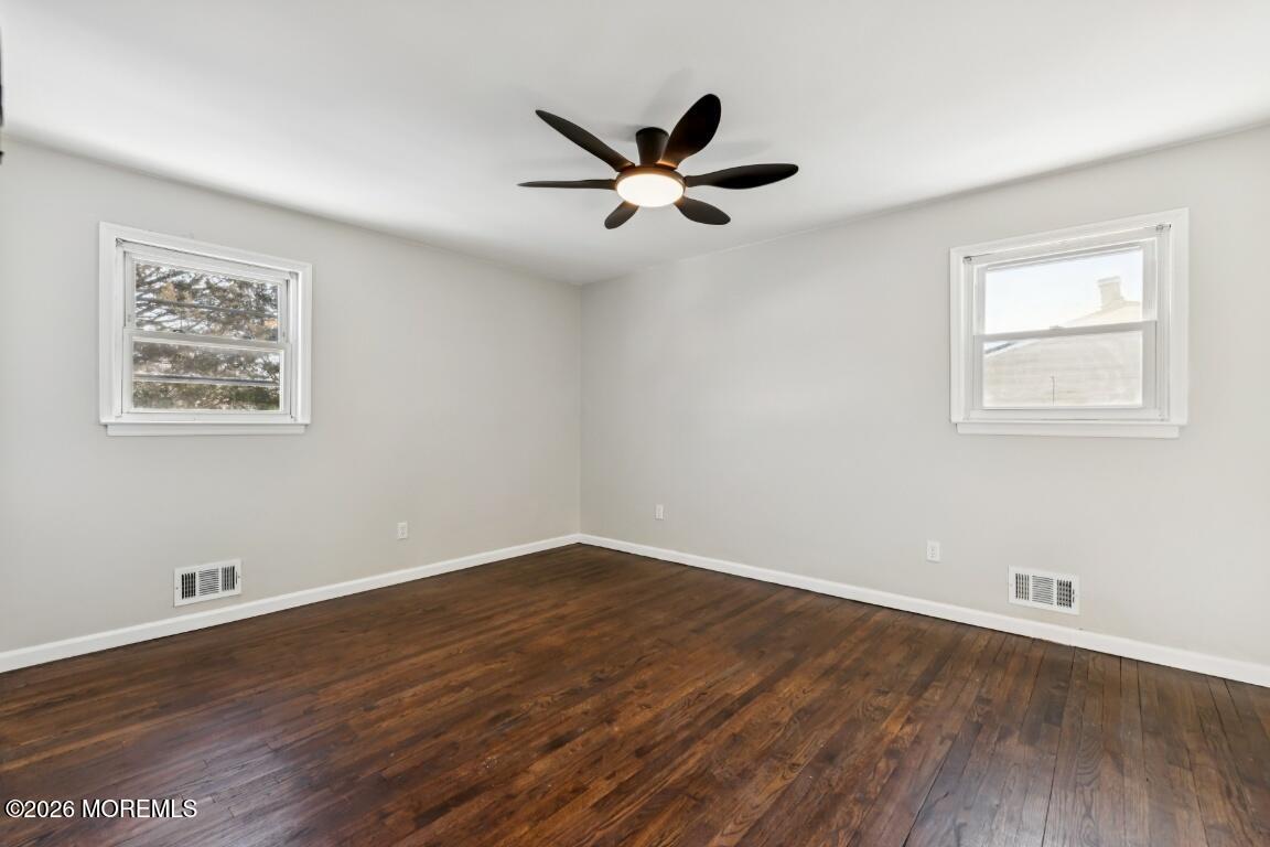 96 Twin Rivers Drive Toms River, NJ 08753 - Photo 15 of 37 a view of a room with wooden floor and a ceiling fan