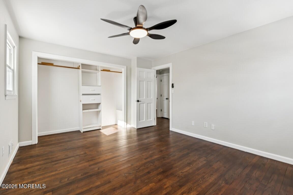 96 Twin Rivers Drive Toms River, NJ 08753 - Photo 17 of 37 an empty room with wooden floor ceiling fan and windows
