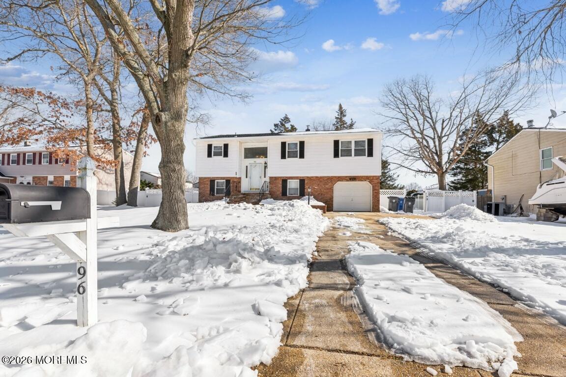 96 Twin Rivers Drive Toms River, NJ 08753 - Photo 2 of 37 a front view of a house with a yard covered in snow