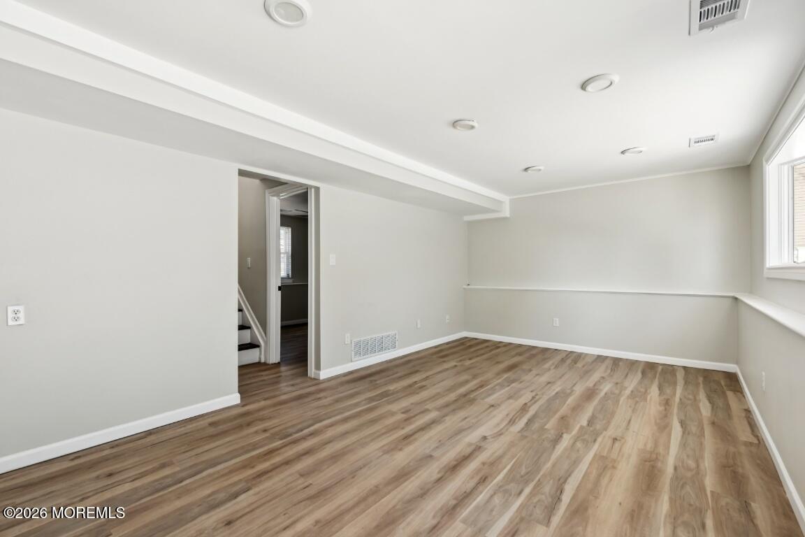 96 Twin Rivers Drive Toms River, NJ 08753 - Photo 32 of 37 a view of an empty room with wooden floor