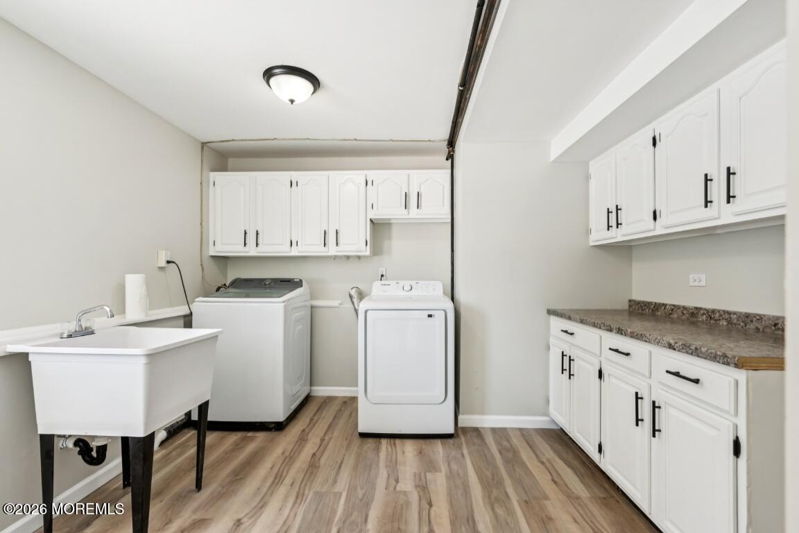 96 Twin Rivers Drive Toms River, NJ 08753 - Photo 36 of 37 a utility room with cabinets washer and dryer