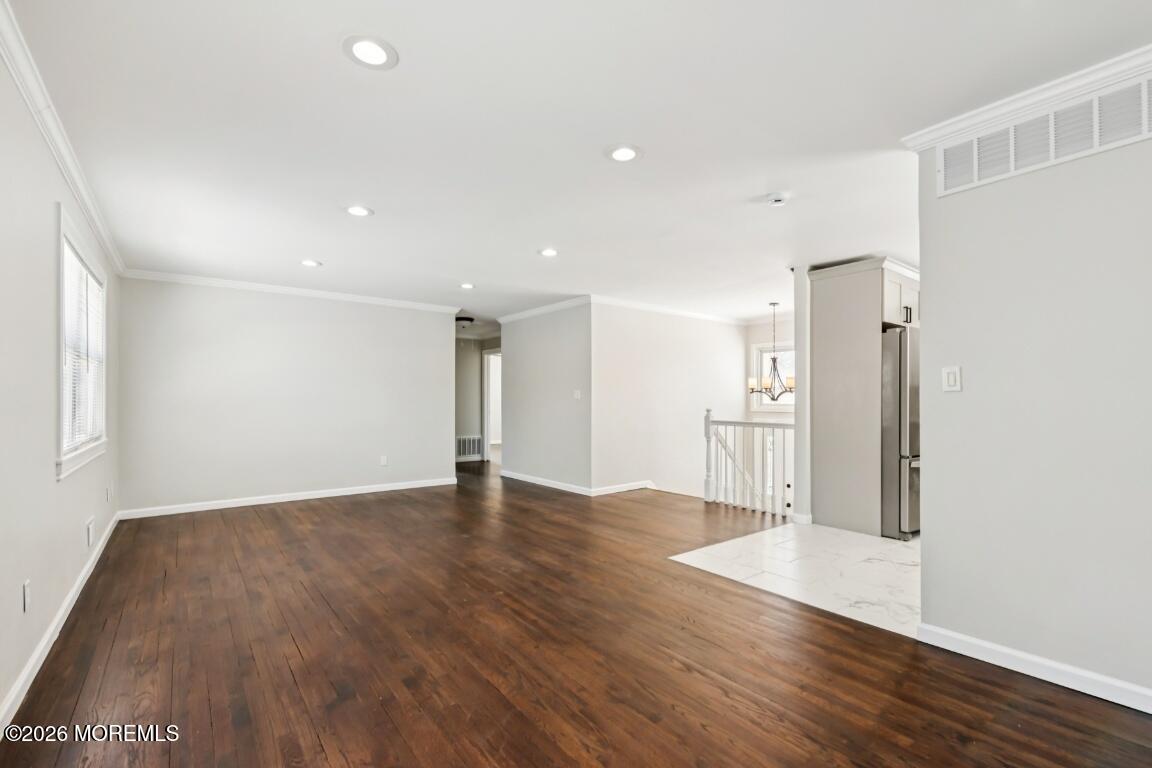 96 Twin Rivers Drive Toms River, NJ 08753 - Photo 6 of 37 a view of an empty room with wooden floor