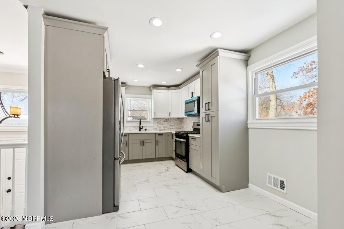 96 Twin Rivers Drive Toms River, NJ 08753 - Photo 9 of 37 a kitchen with a refrigerator and white cabinets