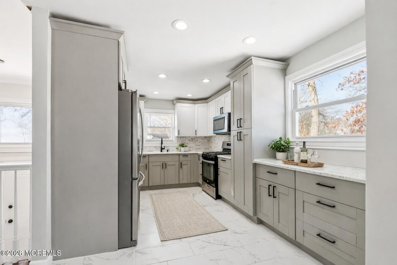 96 Twin Rivers Drive Toms River, NJ 08753 - Photo 10 of 37 a kitchen with white cabinets and appliances