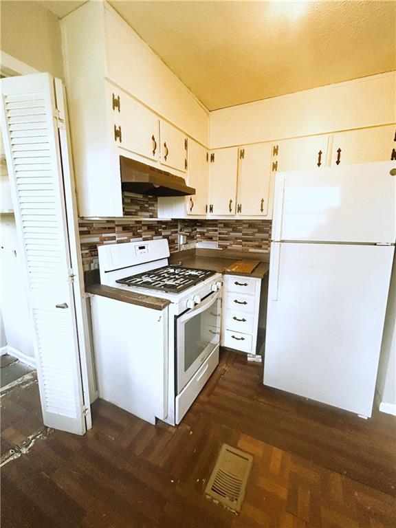 2115 Venesa Circle Austell, GA 30168 - Photo 11 of 28 a white refrigerator freezer and a stove sitting inside of a kitchen