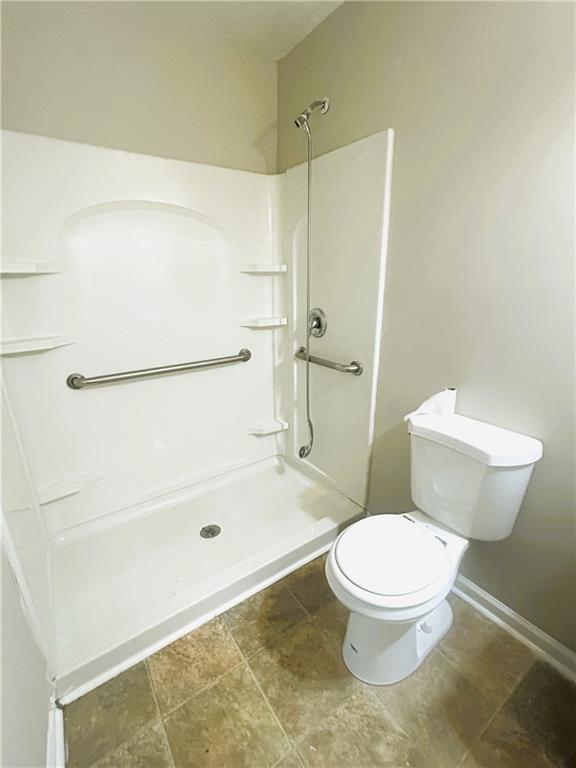 2115 Venesa Circle Austell, GA 30168 - Photo 3 of 28 a white toilet sitting next to a bath tub and a shower
